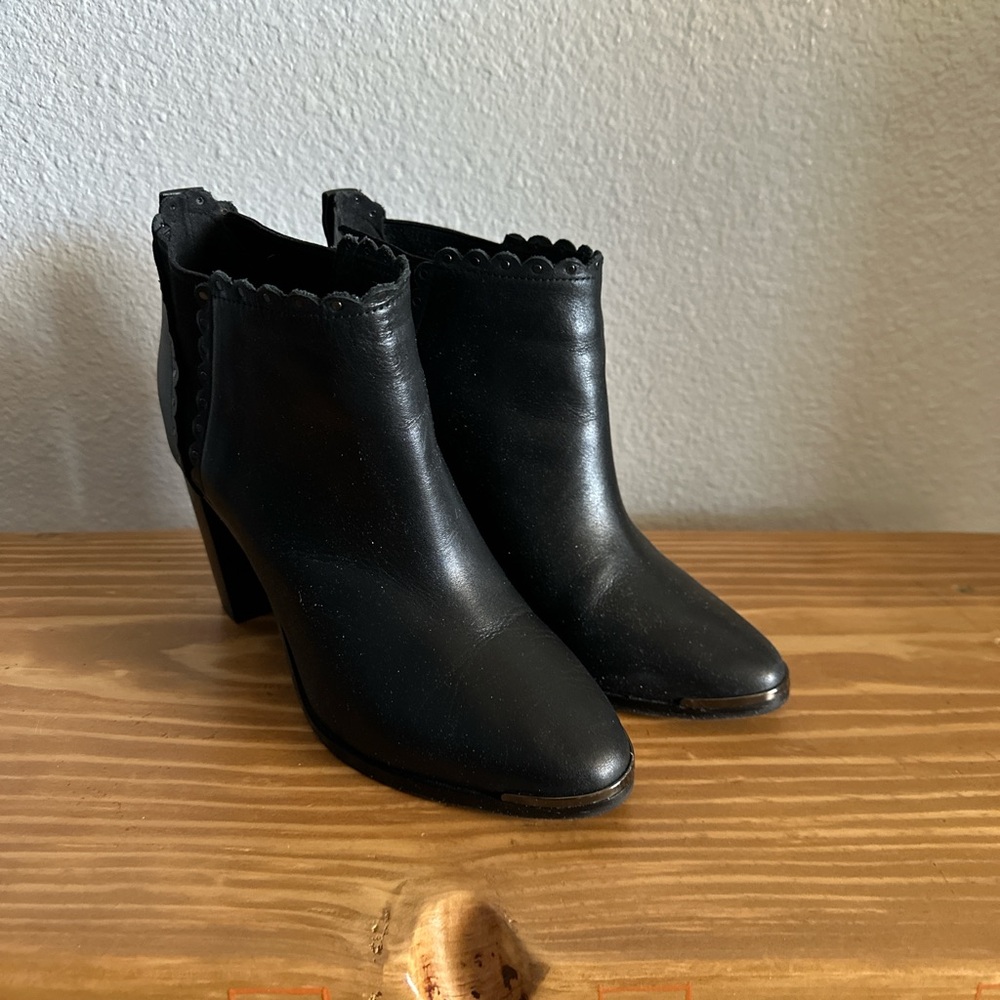 Black booties with scalloped edges